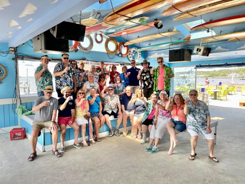 The setup crew for the Boat Drinks Bacchanal fundraiser enjoys a break and a libation after their work is done.